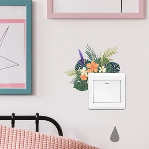 Close-up of tropical floral switch sticker with orange hibiscus and palm leaves on wall