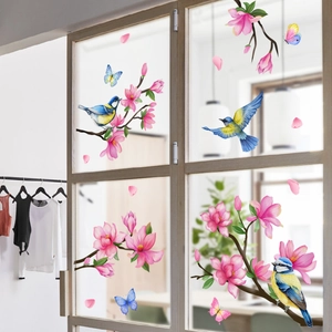 Detail of bird and magnolia flower wall stickers on a glass door in a cozy room