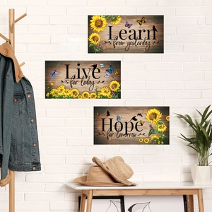 Three-piece sunflower wall art set with inspirational quotes on white brick background