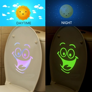 Luminous toilet lid stickers with cartoon smiley face showing day and night glowing effect