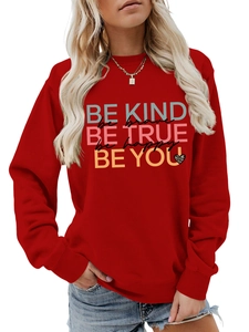 Detail of red crewneck sweatshirt with BE KIND BE TRUE slogan and leopard heart print