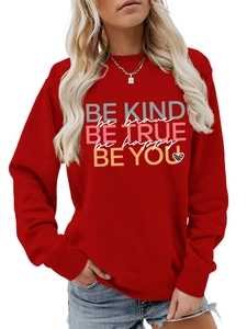 Detail of red crewneck sweatshirt with BE KIND BE BRAVE colorful inspirational quote print