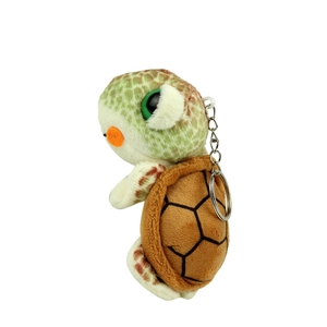 Cute plush sea turtle keychain with large green eyes and brown shell on white background
