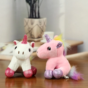 Cute pink and white plush unicorn keychains with rainbow tails and glittery horns