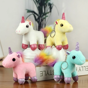 Close-up of plush unicorn keychains with rainbow tails and shiny sequin details