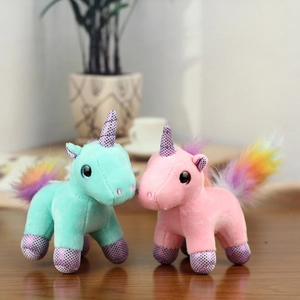 Close-up of pink and blue unicorn plush keychains with glitter horns and colorful tails