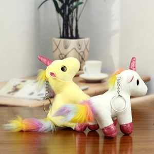 Macro view of colorful unicorn plush keychains featuring sequins and rainbow manes