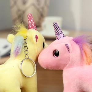 Detail of plush unicorn keychains with colorful manes and shiny sequined horns