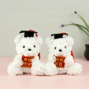 Close-up of white graduation plush bears with black mortarboards and red tassels