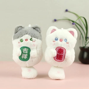 Plush cat pendants featuring embroidery with lucky charms in a cozy home setting