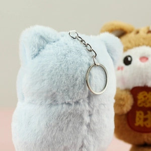 Detail of plush cat charms in blue and brown with soft fur and silver keychains