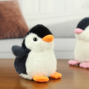 Close-up of soft plush penguin keychain with fluffy texture and cute orange beak