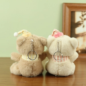 Rear view of cute plush bears wearing striped sleeping hats and matching scarves