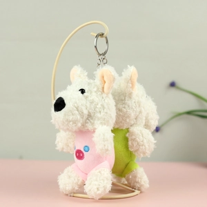 Detail of plush West Highland White Terrier keychains wearing colorful outfits