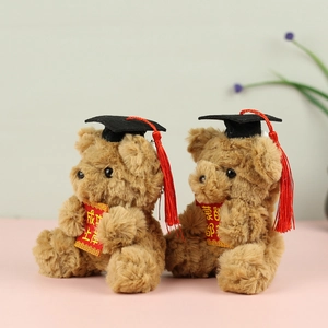 Pair of brown graduation teddy bears with mortarboard caps and red success scrolls