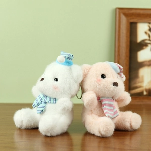 Cute plush teddy bear keychains in cream and pink with striped hats and scarves
