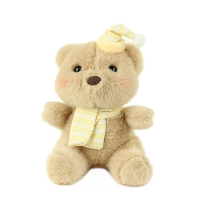 Cute plush bear keychain with yellow striped knit scarf and hat on white background