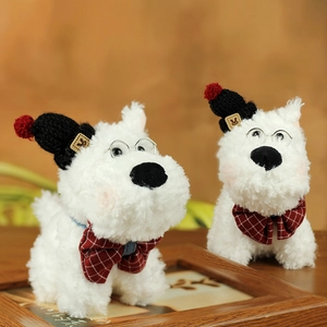 Close-up of plush Westie puppy doll with red checkered bowtie and round glasses