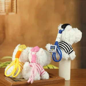 Detailed view of plush West Highland dog keychains with colorful striped knitted lanyards