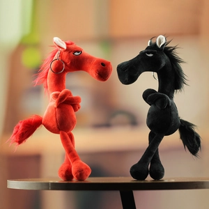 Detail shot of red and black plush horse keychains with funny expressions on a wood base