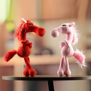 Detailed view of red and pink zodiac horse plush keychains with metallic ring clips