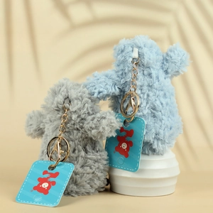 Cute plush penguin keychain set in blue and grey with soft fur and metal clips