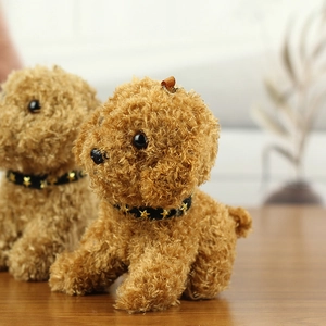 Close-up of curly brown teddy dog plush keychain with star collar and hanging loop