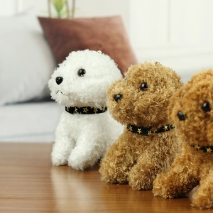 Close-up of curly plush teddy dog toys in white and brown with star collars