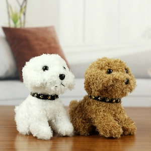 Close-up of cute white and brown teddy dog plush toys with star collars on wood