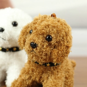 Close-up of plush puppy keychains with star-patterned collars and soft curly fur
