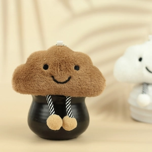 Detailed view of a cute brown plush cloud charm with striped legs on a black pot