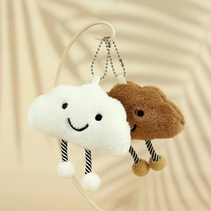 Detail of plush cloud pendants in white and brown with cute smiling faces and bead chains