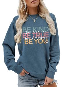 Detail of blue-gray sweatshirt with BE KIND inspirational text and leopard heart print