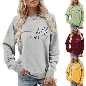 Detail view of colorful Hello Forty heart print sweatshirts in grey, green, red, and yellow