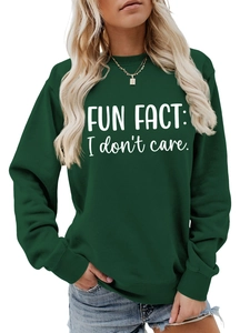 Detail of dark green crewneck sweatshirt with Fun Fact I Don't Care slogan print