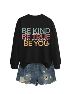 Detail of Be Kind graphic sweatshirt with leopard heart and distressed denim shorts