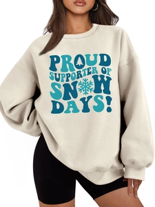 Detail of cream oversized sweatshirt with Snow Days blue graphic print and fleece texture
