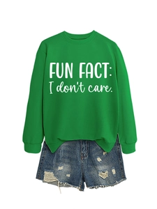 Flat lay of a green sweatshirt with white text and distressed blue denim shorts
