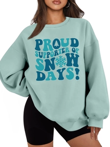 Close-up of Teal oversized sweatshirt with SNOW DAYS! graphic and soft ribbed collar