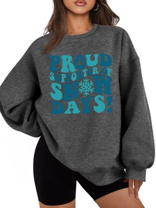 Close-up of thick dark grey sweatshirt fabric texture and snow days printed slogan
