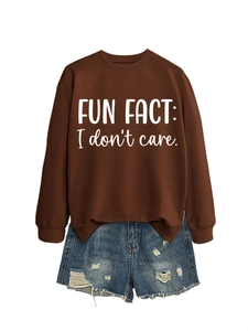 Detail of Fun Fact I Don't Care lettering on brown round neck sweatshirt with denim shorts