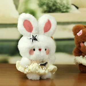 Detail of cute white plush bunny keychain with lace dress and pearl necklace