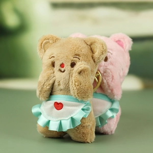 Cute brown and pink plush bear keychains wearing blue ruffled aprons with heart embroidery