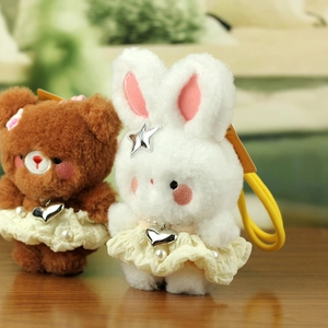 Detail of plush bear and bunny charms with lace dresses, pearls, and elastic rings