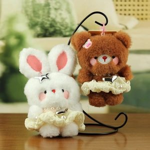 Detail of plush bear and rabbit charms with lace dresses and heart pendants
