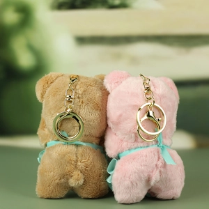 Detail view showing soft plush texture and ribbon bows on cute teddy bear keychains