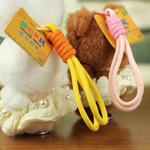 Detail view of plush bear and rabbit pendants with lace dresses and woven straps