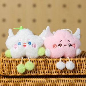 Detail of plush star pendants with cute wings and dangling balls on a woven basket