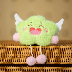 Cute green plush cloud pendant with wings and star limbs sitting in a woven basket