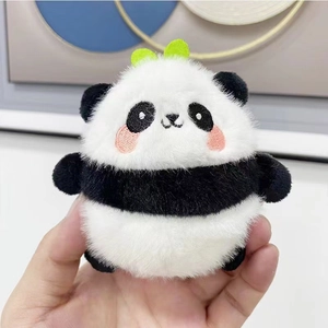 Cute panda plush keychain with green sprout and pink cheeks held in hand